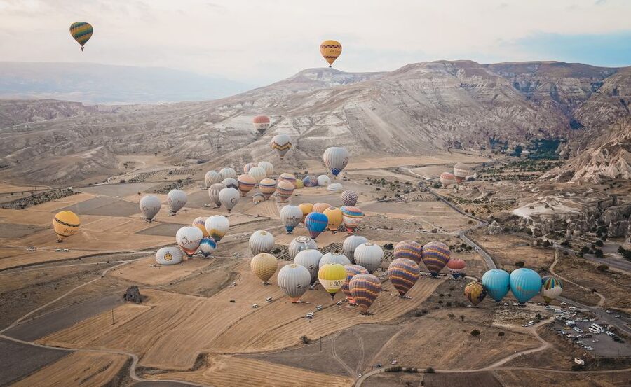 Hot air balloons in Goreme red valley - From Hotel Pickup to Lift-Off in the Early Morning